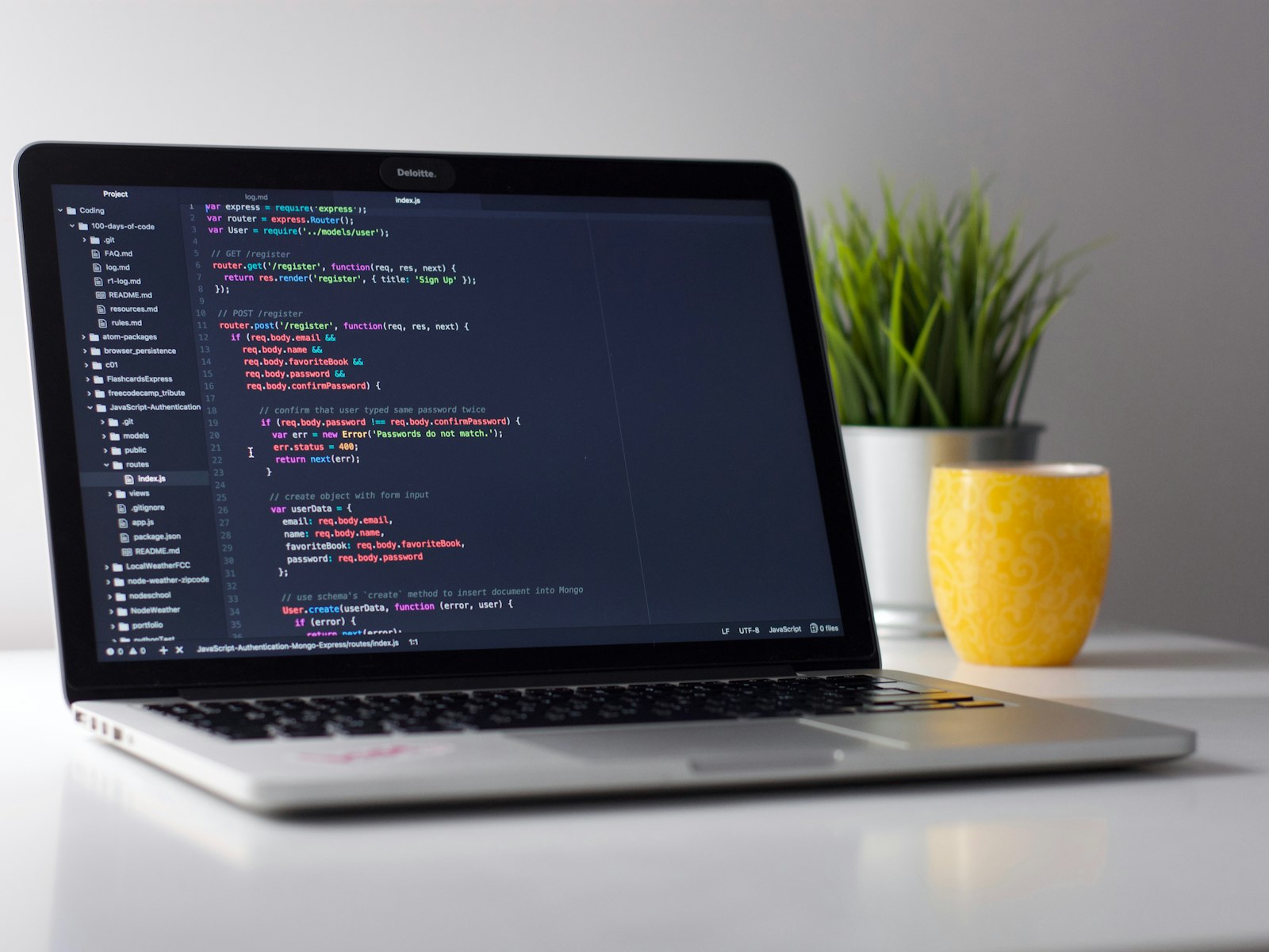 Laptop with code editor on a clean desk