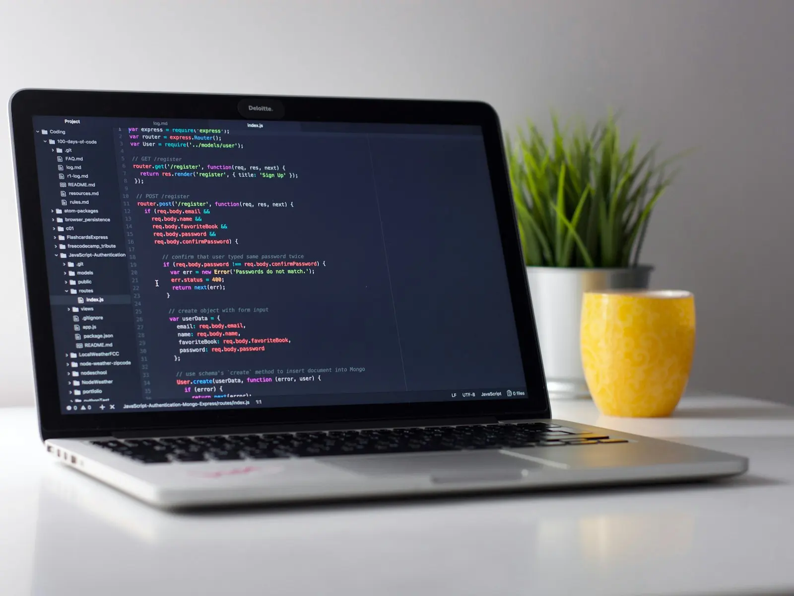 Laptop with code editor on a clean desk